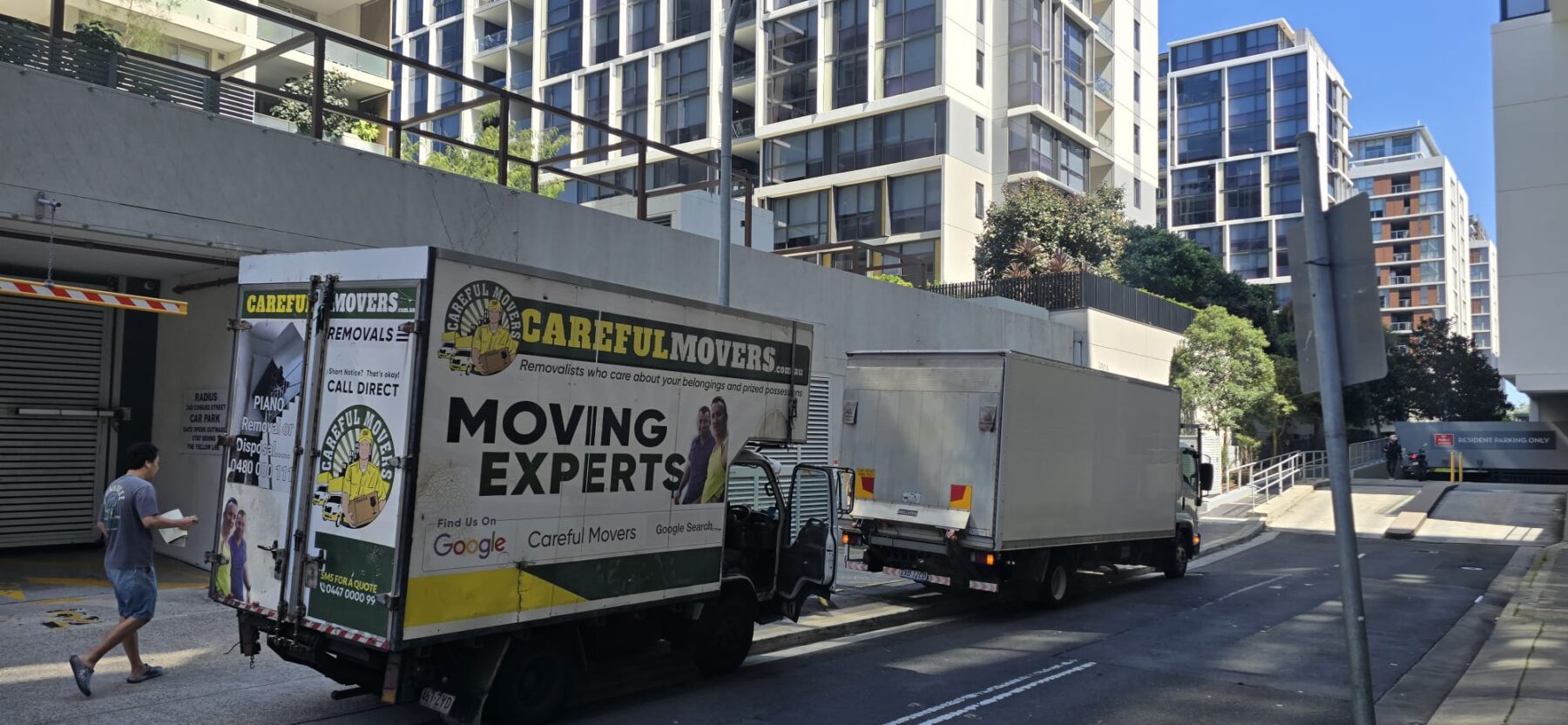 Careful Movers trucks completing an apartment move near Mascot