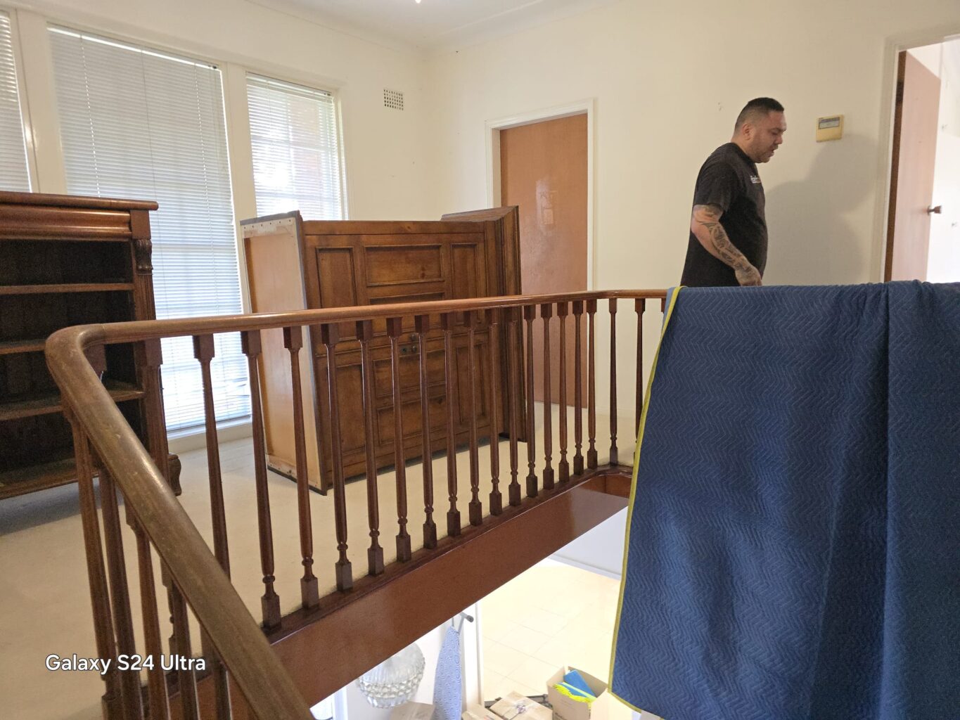 Furniture staged at an upper-floor landing during a Sydney move