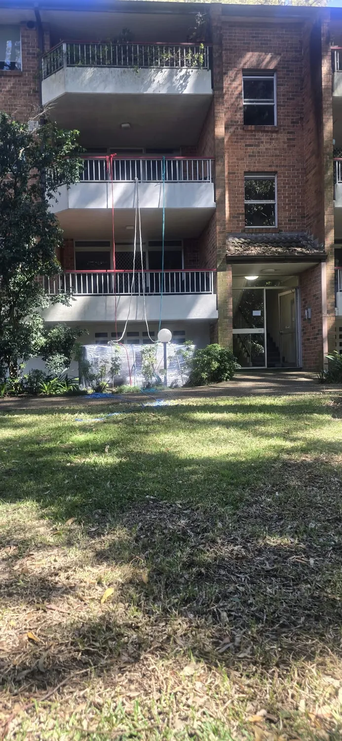 Wrapped lounge on the ground after a balcony lift at a Hornsby apartment