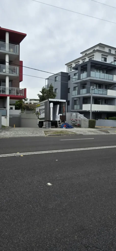 Careful Movers truck parked outside a Hornsby apartment building